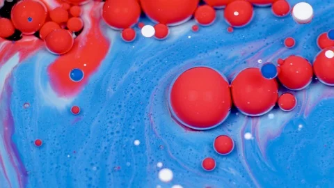 Amazing red and blue bubbles of paint on the oil surface. Paint in oil. Stock Footage 105187872