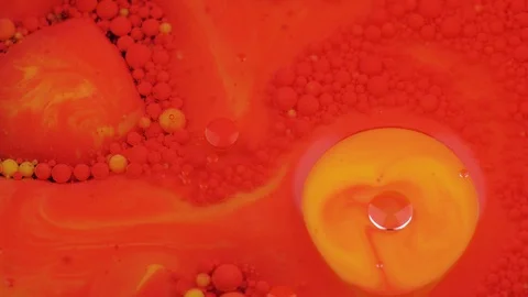 Amazing red and yellow bubbles of paint on the oil surface. Paint in oil. Stock Footage 105175875