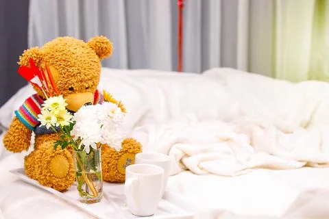 Amazing romantic breakfast in bed with two white cups, a vase of flowers and a Stock-Fotos