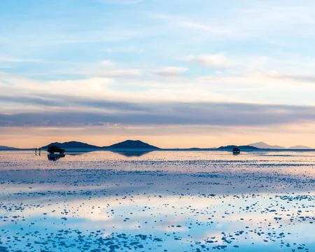 Amazing scenery of the spacious Salar de Uyuni with cars on it Stock Photos