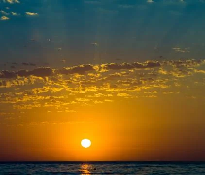 Amazing sea sunset, the sun, waves, clouds Stock Photos