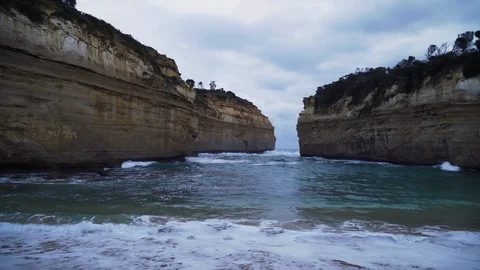 Amazing sheer size cliffs and narrow opening out to sea at Lord Ard Gorge Stock-Footage 125258257