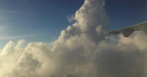 Amazing shot of fluffy clouds from an airplane window Stockbeeldmateriaal 238486622