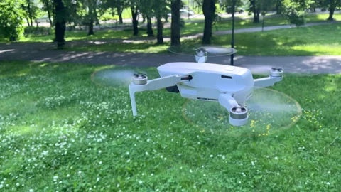 Amazing Side Closeup View Shot of Drone Hovering in Windy Green Park Video stock 311936558