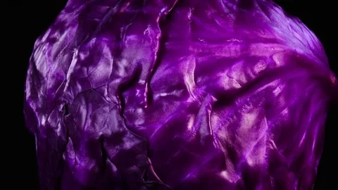 Amazing side of red cabbage close up, rotating to the right on black background Stock Footage 77762535