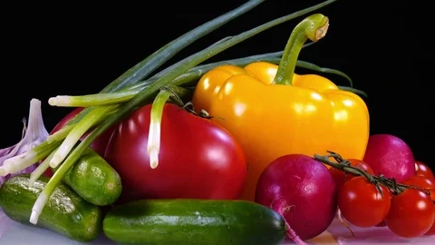 Amazing side view of vegetables set close up, laying on white plate and rotating Stock Footage 78348351