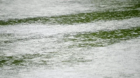 Amazing slow motion of rain dropping on green water surface with smooth tongue Stock Footage 52769869