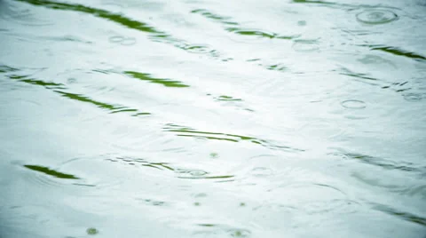 Amazing slow motion of rain dropping on the blue water surface. Stock Footage 53794848