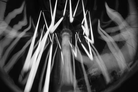 Amazing spiral electric current inside a retro crystal clear light bulb. Stock Photos