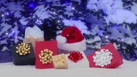Amazing stack of colorful gifts under snowy glowing Christmas tree on background Stock Footage 204499874