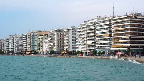 Amazing steady low angle shot of crowded modern hotel villas sea front quay of Stock Footage 94923308