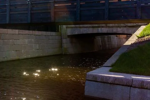 Amazing sun exposure on the water surface in the city river channel. Stock Photos