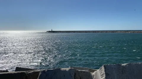 Amazing sunset on a beach with perfect, clear sky. Lighthouse on the view Video stock 137941542