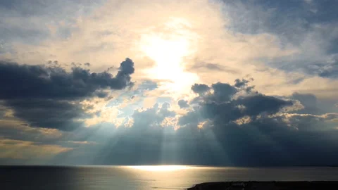 Amazing sunset behind the clouds with the rays above the open sea. Aerial view Stock Footage 157018342