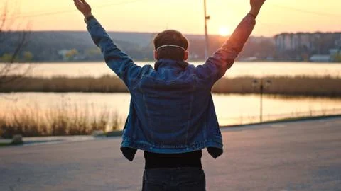 Amazing sunset in the empty park guy enjoying the sunset he take the protective Stock Photos