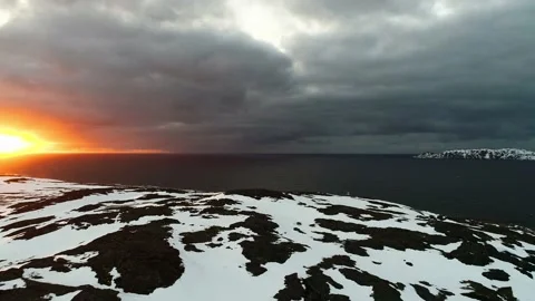 An amazing sunset over the ocean with storm clouds. The drone flies in the black Stock Footage 169464229