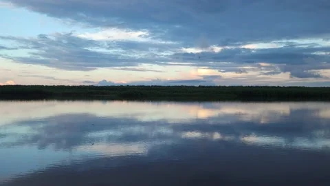 Amazing sunset on the river. Reflection of the sky in the water. 4k Stock Footage 197073690
