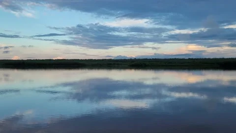 Amazing sunset on the river. Reflection of the sky in the water. 4k Stock Footage 197073696