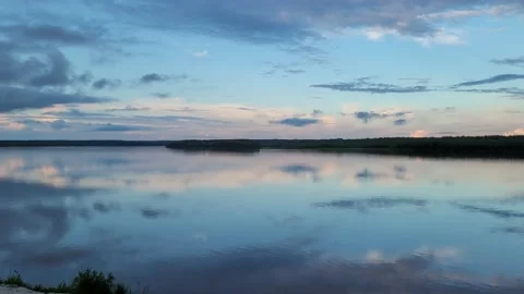 Amazing sunset on the river. Reflection of the sky in the water. 4k Video stock 197073702