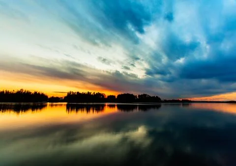 Amazing sunset sky reflection on the river Stock Photos