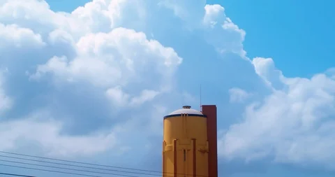 Amazing time lapse of clouds passing behind an old water-tower Stock-Footage 98423456