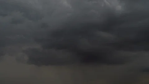 Amazing time-lapse of dramatic dark gray clouds, coming in frame. Stock Footage 98106169