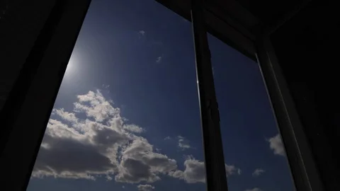 Amazing time lapse: the sun appears in window on the background with fluffy Stock Footage 129634482