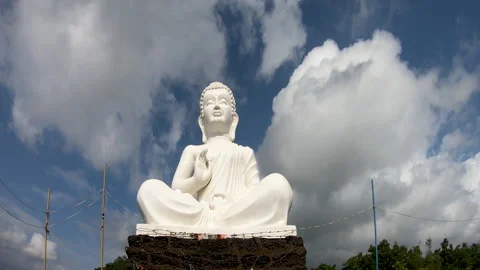 Amazing Time Lapse video of Lord Buddha statue in white sitting in meditation. Stock Footage 140086653