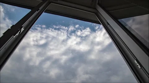 Amazing time lapse: view through window on fluffy clouds floating by the sky Stock Footage 131002948