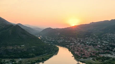 Amazing timelapse of sun setting over mountains behind the old Georgian town Stock Footage 112366734