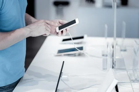 Amazing tiny smartphone in the hands of a customer Foto stock