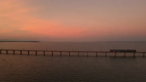 Amazing train on a floating railway bridge in the lake during beauty sunset sky Stock Footage 160587963