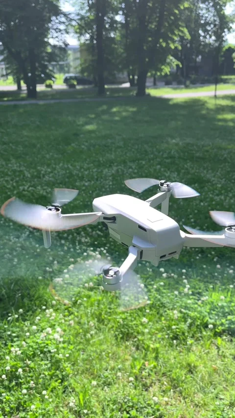 Amazing Vertical Arc Closeup Shot of Drone Hovering in Green Park Stock Footage 311936473
