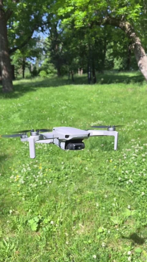 Amazing Vertical Arc Closeup Shot of Drone Hovering in Green Park Stock Footage 311936478