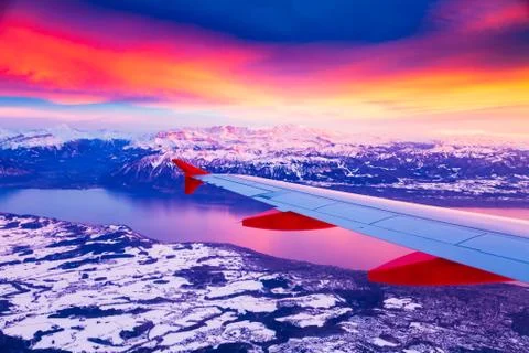 Amazing view from the airplane window during the sunset over mountains in Stock Photos
