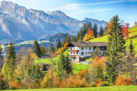 Amazing view of  Alpine green fields and traditional wooden houses view of .. Stock Photos