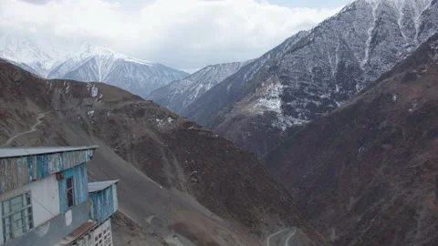 Amazing view of caucasian mountains wit snowy peaks. wooden house on the Stock Footage 200857112