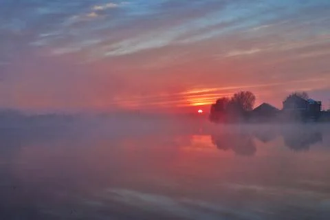 Amazing view at first sun rays at mystery foggy morning Stock Photos