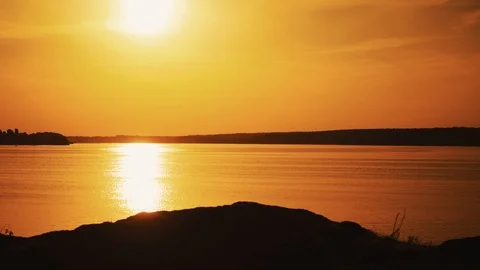Amazing view of a golden sunset path over water surface and a biker. Stock Footage 111433924
