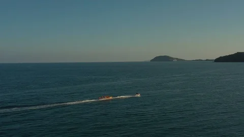 Amazing view of moving fast speed boat on sea water close to islands in sunset a Stock Footage 124416099