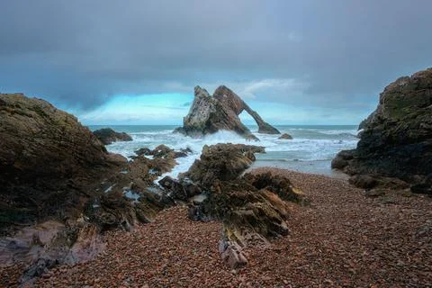 Amazing view of the sea cliffs, in the shape of an arch and stones in the Stock Photos