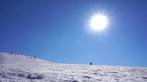 Amazing view of snow capped hill with skiers and snowboarders on bright day Stock-Footage 81549968