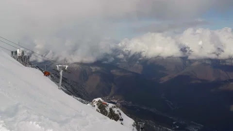 Amazing view from the top of the mountain to the clouds at the winter resort Stock Footage 232163478