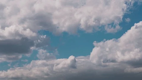 Amazing volumetric clouds fly fast against the blue sky Stock Footage 128961019