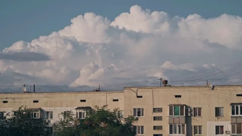 Amazing volumetric clouds over an multi-story building Stock Footage 126885225