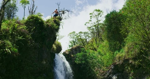 Amazing waterfall cliff jumping Stock Footage 105891173