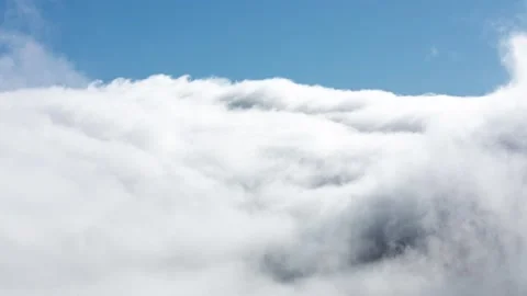 Amazing Waterfall Clouds Flowing into Valley With Blue Sky Stock Footage 137773595