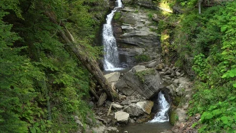 Amazing waterfall creates small lakes among green forest Stock Footage 116873858