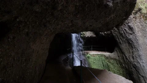 Amazing waterfall deep inside of the mountain. Tunnel, cave passage for hikers Stock Footage 171294089