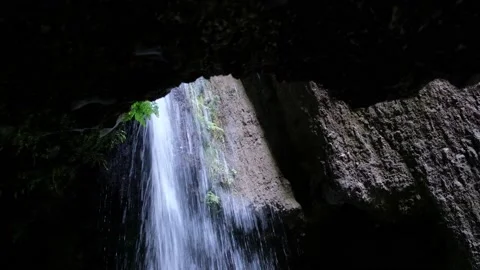 Amazing waterfall deep inside of the mountain. Water running down of a cave Stock Footage 171558558